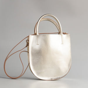 Minor History: The Convertible Champagne Arc Bag